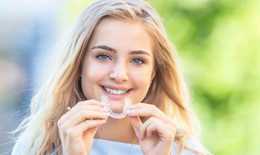 How does Invisalign move teeth?